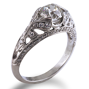 Style:ER377J ~ Bead set diamonds surround a round brilliant center diamond set in platinum.