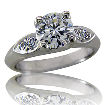 Style:ER424 ~ A round brilliant prong set diamond enhanced with two bead set diamonds on each side.