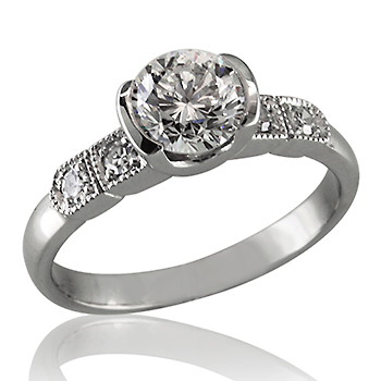 Style:ER428 A semi bezel set, round brilliant cut diamond embellished with bead set round diamonds.